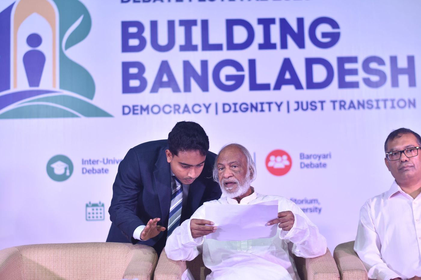 Shazid talking with a guest on stage